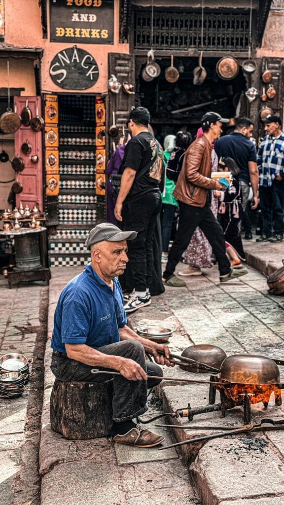 Top Things That Make Fez Special: History & Handicrafts 95
Seffarine Square, located near the Qarawiyyin Mosque in the old medina of Fez, is home to some of the city’s most skilled and dedicated traditional artisans. This historic square echoes with the sounds of hammers on metal, and the quiet focus of generations of craftsmen preserving centuries-old trades.🛠️ Who You'll Meet Here:
Coppersmiths (Saffarine)
The square is named after them. These artisans shape and engrave copper and brass items by hand — including trays, teapots, lanterns, and bowls — using ancient techniques passed down through generations.Metal Engravers
They add delicate patterns and calligraphy to copper and brass objects, turning everyday items into works of art.Bookbinders and Quran Restorers
Near the square, especially around the Qarawiyyin Library, you'll find craftsmen who practice traditional bookbinding, repairing ancient manuscripts and restoring sacred texts with care and reverence.🌟 Why It’s Worth Visiting:
It’s a chance to see traditional craftsmanship in action — not as a show, but as a daily reality.You can support local artisans by buying authentic handmade souvenirs that carry cultural and artistic value.It offers a deeper understanding of Fez as a city of knowledge and craft, where tools and books coexist in harmony.