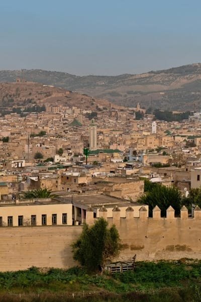 The sturdy, weathered ancient walls of Fes, standing as a testament to history and the city’s fortified past. The image captures the impressive architecture of the city’s protective barriers.