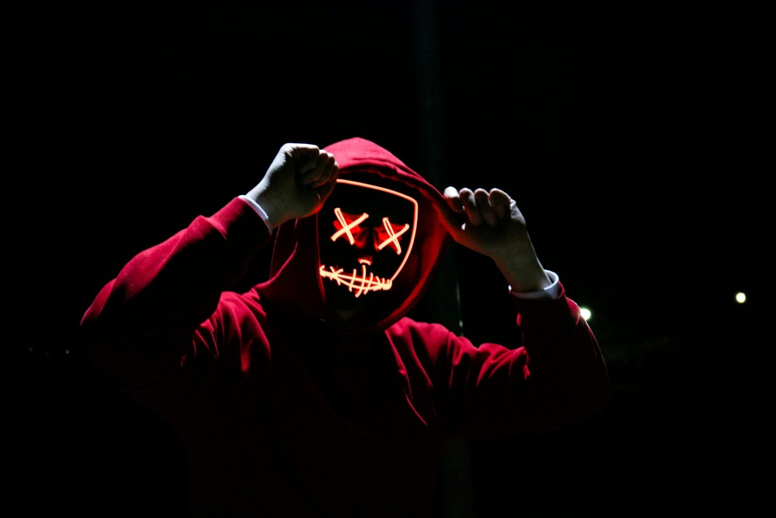 Fes: Volubilis Roman Ruins, Mouly Idriss, & Meknes Day Trip 8 A spooky illuminated mask figure with a red hoodie in a dark setting, perfect for Halloween themes.