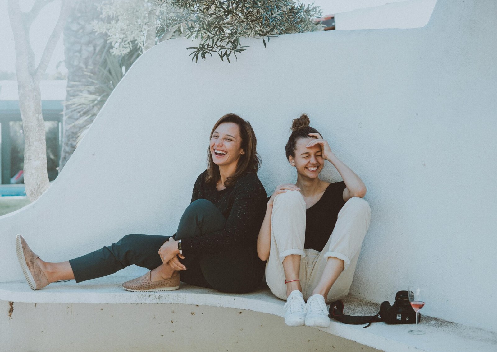 2-Day Shared Group Tour from Fes to the Desert 8 Two women laughing together outdoors, enjoying leisure time and friendship.