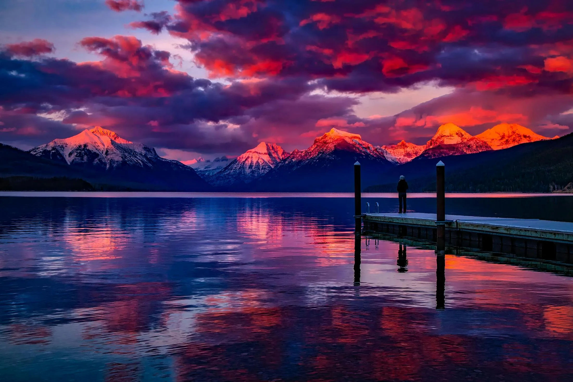 Night tours (3 to 4 hours) 6 Stunning sunset over a serene lake with colorful sky and majestic mountains.