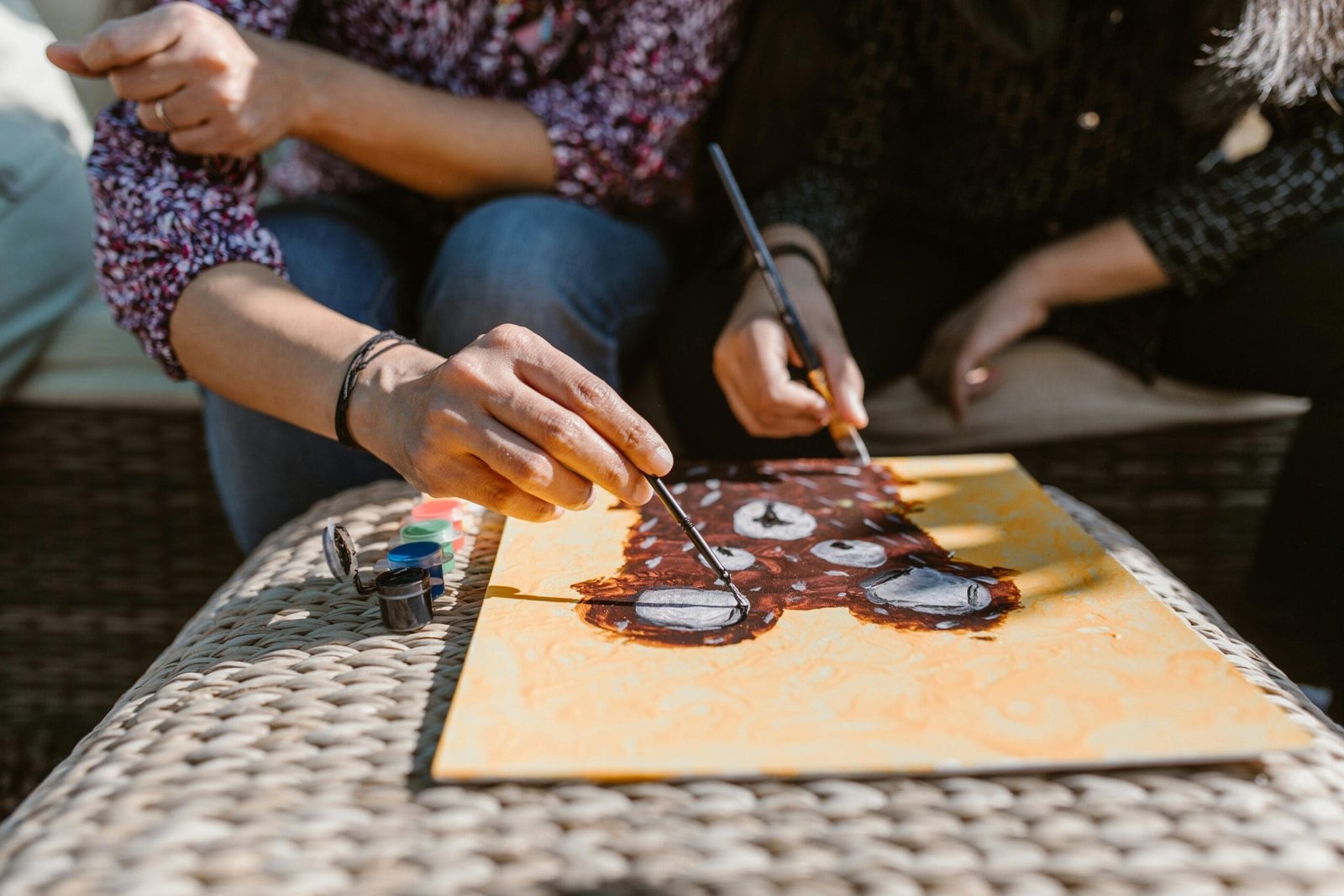 Tourist Transport 10 Adults enjoying a creative painting session outdoors, focusing on art and bonding.
