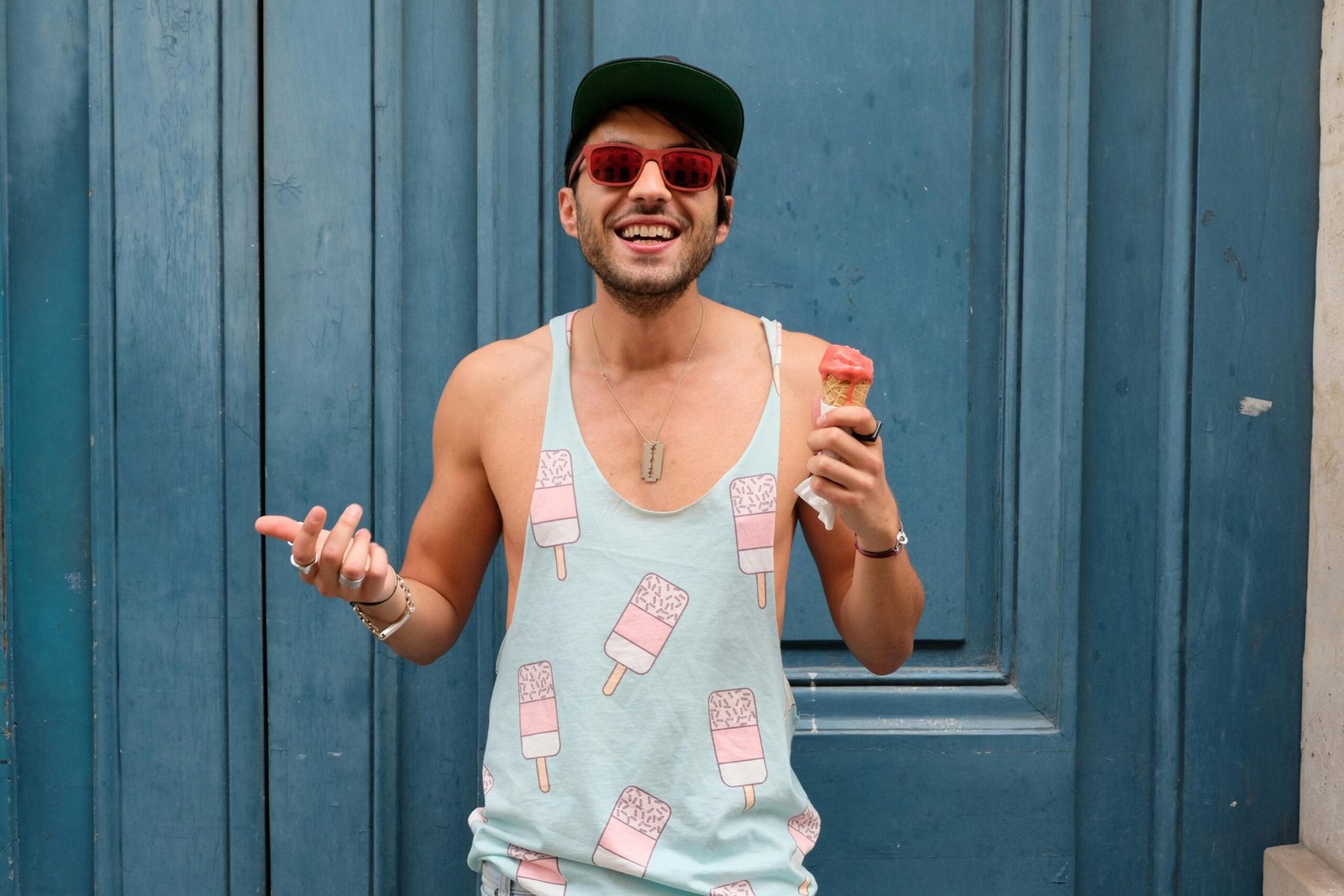 Historical Landmarks Tour Outside Fes' Old Walls 5 Happy man in Paris enjoying ice cream against a blue door. Fashionable and fun summer vibe.