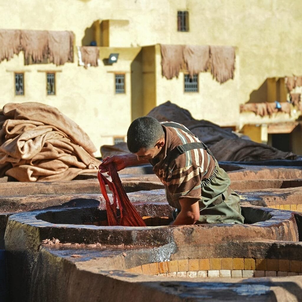 Top Things That Make Fez Special: History & Handicrafts 63 What truly sets these artisans apart is their steadfast adherence to traditional methods, a practice passed down through centuries. Picture them carefully preparing the natural dyeing agents – lime, the surprising effectiveness of pigeon droppings, and the vibrant hues extracted from poppies or the precious threads of saffron. Their knowledge of these natural ingredients and their application is a testament to a deep connection with the land and its resources.Their daily routine is a manual endeavor, a labor of love that demands both physical strength and meticulous attention to detail. It is a demanding job, often carried out amidst strong aromas and intense physical effort. Yet, it is a profession imbued with immense pride in their craftsmanship and the legacy they uphold.The significance of their work extends far beyond the beautiful leather they produce:Guardians of History: These tanners are the living custodians of a craft that stretches back over a millennium. They are the vital link to Fez's glorious past, ensuring that these ancient techniques are not lost to the passage of time.
Champions of Quality and Authenticity: In a world increasingly dominated by mass production, their handmade leather goods stand as a testament to the enduring value of quality, durability, and authentic craftsmanship. Each piece carries the mark of human skill and dedication.
The Beating Heart of Fez's Artistic Soul: These artisans are more than just workers; they are the embodiment of Fez's artisanal spirit. They keep ancestral knowledge alive, their workshops serving as vibrant hubs of tradition in a rapidly modernizing world.
A Living Tapestry of Human Endeavor: To witness these tanners at work is to step into a living history book. It's a profound experience that speaks to the resilience of the human spirit, the beauty of patience, and the enduring power of tradition. Their dedication is a powerful reminder of the artistry and skill that lies at the heart of Fez.