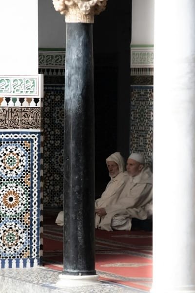 A panoramic view over the rooftops of Fez medina, highlighting the green tiled roofs and the minaret of the historic Al-Qarawiyyin Mosque and University. This image symbolizes Morocco’s deep-rooted knowledge, spirituality, and the cultural heart of the city.