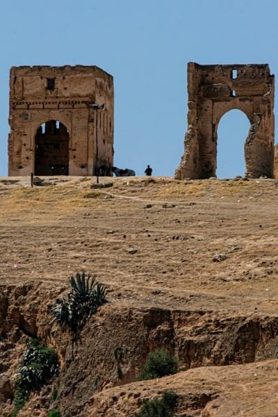 The historical ruins of a tower (likely the South Tower) overlooking Fez, providing a unique panoramic view of the bustling medina and surrounding landscapes. It is an ideal spot for photography and experiencing the city's beauty from above.