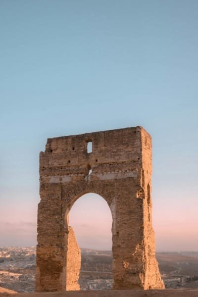 The ruins of a historical northern tower providing a strategic panoramic view over the ancient city of Fes. The robust structure is a symbol of Fes' rich heritage and offers a stunning perspective of the medina's intricate maze of alleys and rooftops.