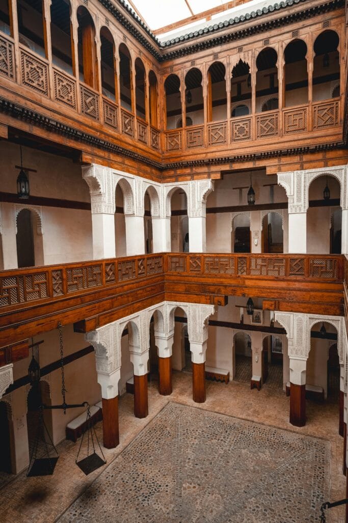 Why Is Fez, Morocco, Famous? 24 Located in the heart of the old medina of Fez, Nejjarine Square is one of the city's most beautiful and iconic historical squares. The square is named after the carpenters (or "najjarine") who have practiced their craft here for centuries, filling the space with the spirit of handmade artistry. 🏛️ Key Attractions: Nejjarine Museum of Wooden Arts and Crafts: Situated inside a beautiful 18th-century building, this museum showcases an impressive collection of wooden tools, doors, chests, and artistic pieces that highlight the skill of Moroccan artisans. Nejjarine Fountain: One of Fez's most stunning fountains, adorned with traditional zellige tiles and carved wood, it was historically a water source for travelers and merchants. 🌍 Why Visit? The square is surrounded by traditional shops full of handcrafted wooden furniture, antiques, and art. It blends living craftsmanship with historical architectural beauty. It is a must-see stop during any tour of Fez, conveniently located near major landmarks like Al-Qarawiyyin Mosque and the Spice Souk. Nejjarine Square takes you on a journey through timeless Moroccan art and craftsmanship, offering a rare opportunity to see traditional craft in action.