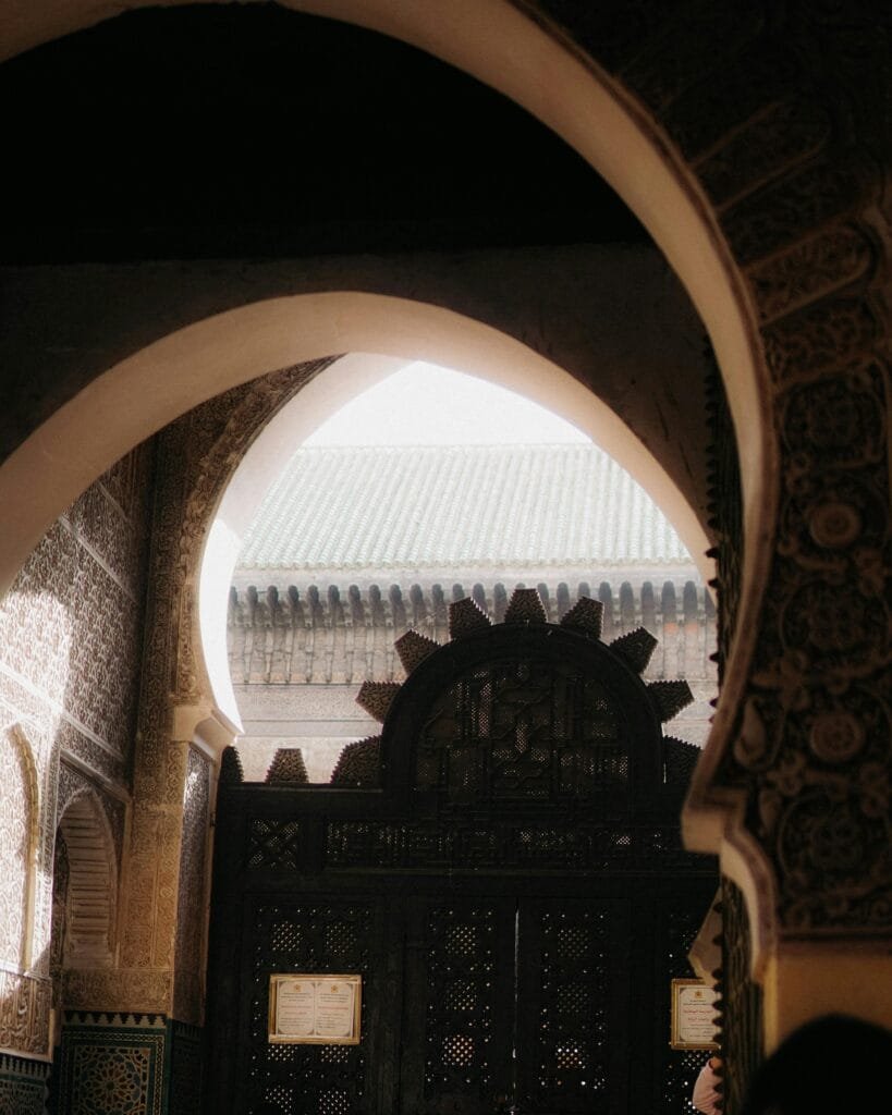 Top Things That Make Fez Special: History & Handicrafts 51 Located in the heart of Fez's old medina, the Bou Inania Madrasa is one of the most impressive religious and architectural landmarks in Morocco. Built in the 14th century by Sultan Abu Inan Faris of the Marinid dynasty, it served both as a school (madrasa) and a congregational mosque — a rare combination in Islamic architecture.🌟 Highlights:
Stunning Moroccan craftsmanship: Intricately carved cedar wood, detailed stucco, and colorful zellige tilework make this madrasa a true masterpiece.Spiritual and educational center: It once hosted some of the best scholars and students of Islamic sciences in North Africa.Tranquil courtyard: A peaceful space with a central fountain, perfect for reflection and appreciating the beauty of traditional design.💳 Entry Fee:
To visit the Bou Inania Madrasa, a small entrance fee of 2 Euros is required — a modest price for a glimpse into centuries of Moroccan history and artistry.📍 Location:
Just steps away from the bustling Talaa Kebira street, the madrasa is easily accessible and an essential stop on any Fez walking tour.Visiting Bou Inania offers a deep dive into the spiritual, artistic, and intellectual heart of historic Fez — don't miss it!