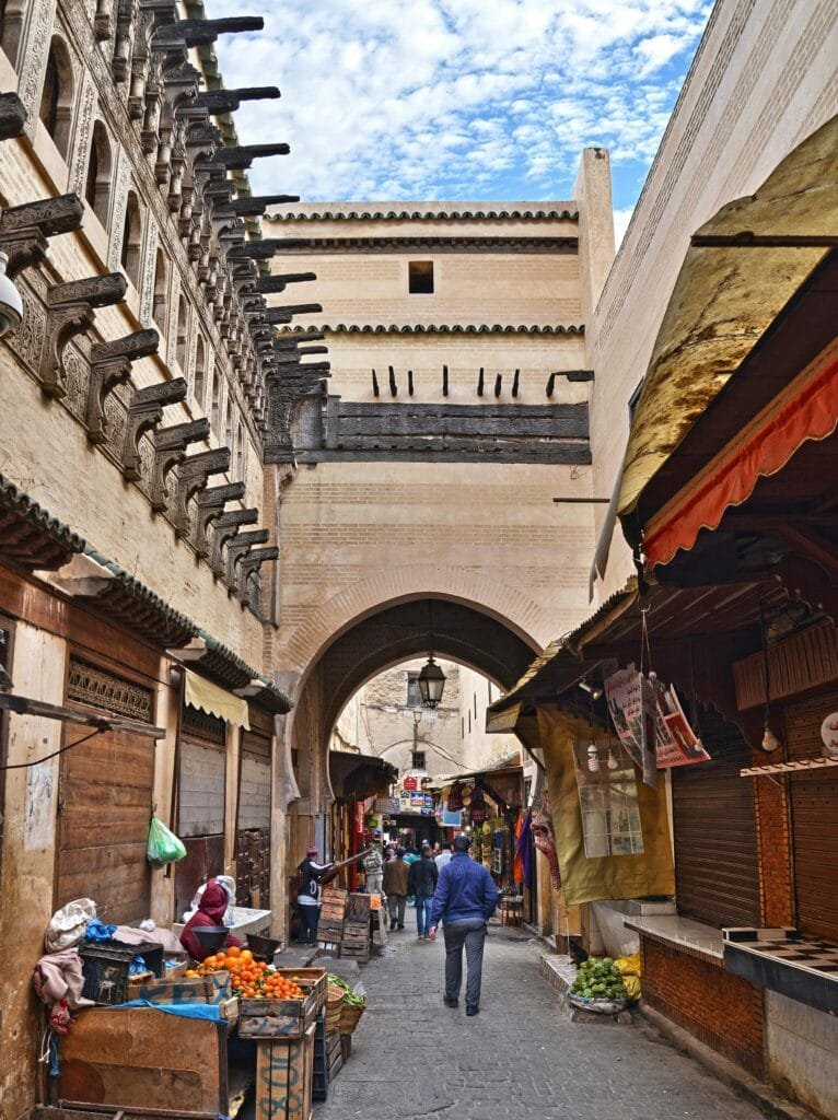This image captures one of Fez's famous gates during a calm time, showcasing the beauty of its historical architecture in a quiet, serene atmosphere."

