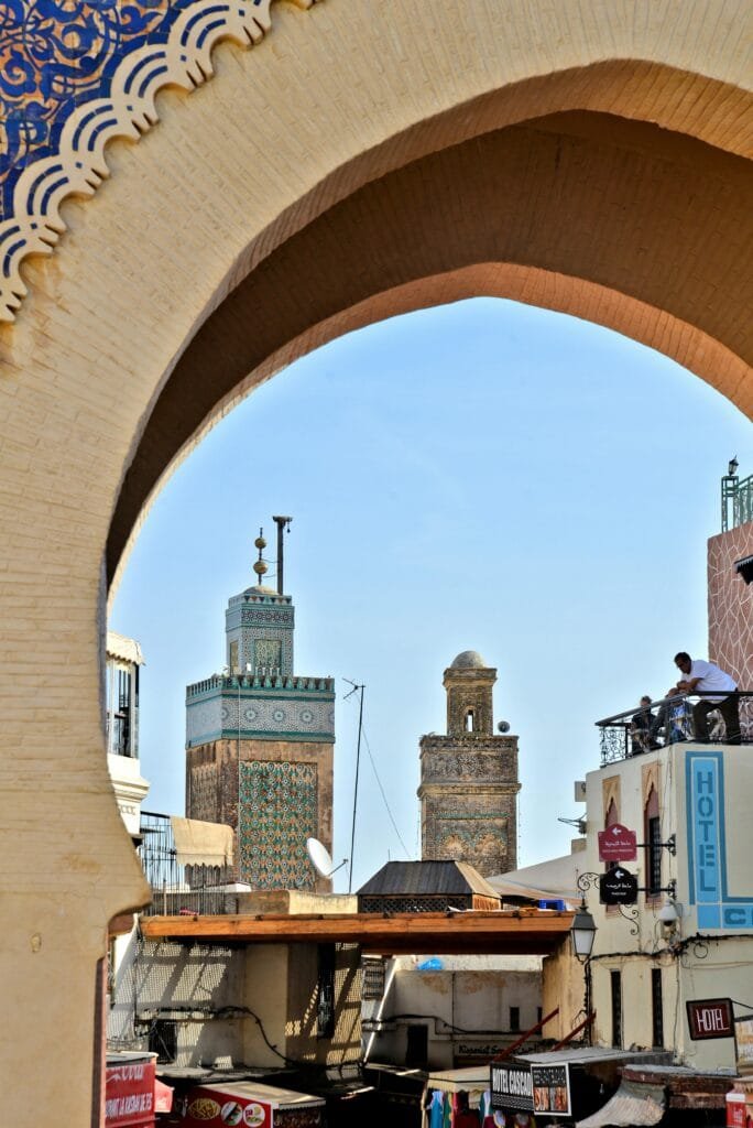 Top Things That Make Fez Special: History & Handicrafts 26 Bab Boujloud, known as the Blue Gate, is the grand and colorful entrance to the old Medina of Fez.
Built in 1913, it’s not just a beautiful landmark but a symbol of the city itself.
The gate’s intricate blue mosaics (representing Fez) on one side and green tiles (symbolizing Islam) on the other welcome travelers into the maze of ancient streets and hidden treasures.
Starting your journey through the Medina at Bab Boujloud offers a magical first impression — a perfect spot for iconic photos and a glimpse into the rich history and vibrant life inside the walls of Fez.