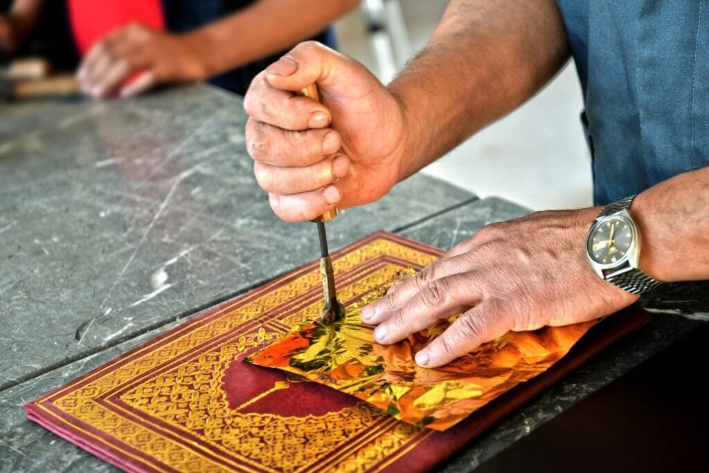 Top Things That Make Fez Special: History & Handicrafts 98 Prepare to be captivated by the artistry and dedication of the leather artisans of Fez, the true masters behind the exquisite handmade bags and accessories you'll discover within the heart of the medina, especially around the legendary tanneries and bustling leather souks. Here, skilled craftsmen take immense pride in transforming the naturally tanned leather – often bearing the rich character of Fez's renowned tanneries – into high-quality, durable, and undeniably stylish items.Imagine witnessing these artisans at work, their hands expertly cutting, stitching, and assembling each piece with meticulous care using time-honored techniques and traditional tools. This dedication to handcraftsmanship ensures that every bag, backpack, wallet, and accessory is truly unique, bearing the individual touch of its creator.The designs you'll encounter are wonderfully diverse, ranging from timeless classic and vintage styles that whisper of Moroccan heritage to more contemporary designs that incorporate the vibrant energy of modern aesthetics. Often, you'll find the incorporation of striking Berber patterns, deeply symbolic embossed motifs, or the rich hues of colorful natural dyes, adding a distinct cultural flair to each creation.Here's why the creations of these leather artisans are so special:Unwavering Authenticity: These are not mass-produced items churned out in factories. Each bag and accessory is a testament to genuine artisanal skill, reflecting the dedication and passion of the individual craftsman.
A Tangible Link to Moroccan Culture: By choosing to purchase directly from these artisans, you are not just acquiring a beautiful item; you are directly supporting the preservation of local heritage and becoming the proud owner of a piece of living Moroccan tradition, imbued with the spirit of Fez.
Exceptional Quality and Timeless Style: Fez leather is celebrated for its remarkable softness, inherent strength, and the exquisite beauty of its natural texture. These qualities, combined with skilled craftsmanship, result in accessories that are both durable and possess a timeless elegance.
An Immersive Experience Awaits: For a truly enriching experience, be sure to visit the leather workshops. Here, you can witness the entire fascinating process firsthand – from the initial stages of tanning to the final meticulous stitches. You might even have the unique opportunity to request custom-made leather items, crafted exclusively to your specifications, a truly personalized memento of your time in Fez.
Embark on a journey to discover the exquisite creations of Fez's leather artisans, and take home not just an accessory, but a piece of the city's enduring craftsmanship and cultural soul.