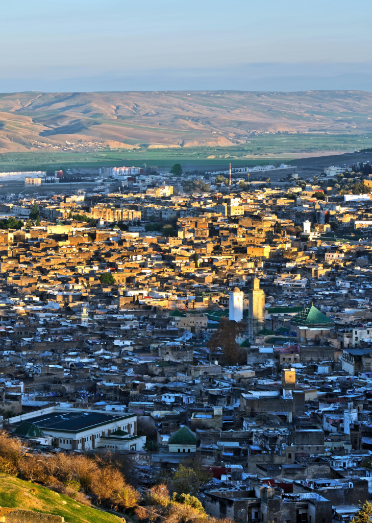 Is Fes, Morocco, Safe? An Honest Guide from a Local Resident 10 A panoramic view of the Moroccan city of Fez at sunset, showcasing traditional rooftops and historic alleys bathed in golden sunlight — reflecting the city's beauty, serenity, and sense of safety.