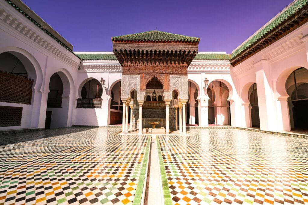 Top Things That Make Fez Special: History & Handicrafts 37 Nestled in the heart of the ancient medina of Fez, the Andalusian Mosque is one of the oldest and most beautiful mosques in Morocco. Built in the 9th century (around 859 AD) by Mariam al-Fihri, the sister of Fatima al-Fihri, founder of the famous Al-Qarawiyyin Mosque, it shares a deep cultural and spiritual connection with it.🌍 Why You Should Visit:
The mosque represents a unique Andalusian-Moroccan heritage, reflecting the history of Muslims who migrated from Andalusia to Fez, bringing their knowledge and culture with them.It features stunning architecture, with decorated arches, intricate stucco work, and finely crafted wooden minbars.Although the mosque is closed to non-Muslims inside, its exterior facade, courtyard, and the surrounding atmosphere offer a unique historical and spiritual experience.📍 Location:
Located in the Andalusian Quarter, directly opposite the Al-Qarawiyyin Mosque across the Fes River. It’s easy to incorporate into a tour of the old city.A visit to the Andalusian Mosque offers a glimpse into the beauty of Andalusian-Islamic heritage, completing your journey through Fez, the city of scholars and artisans.