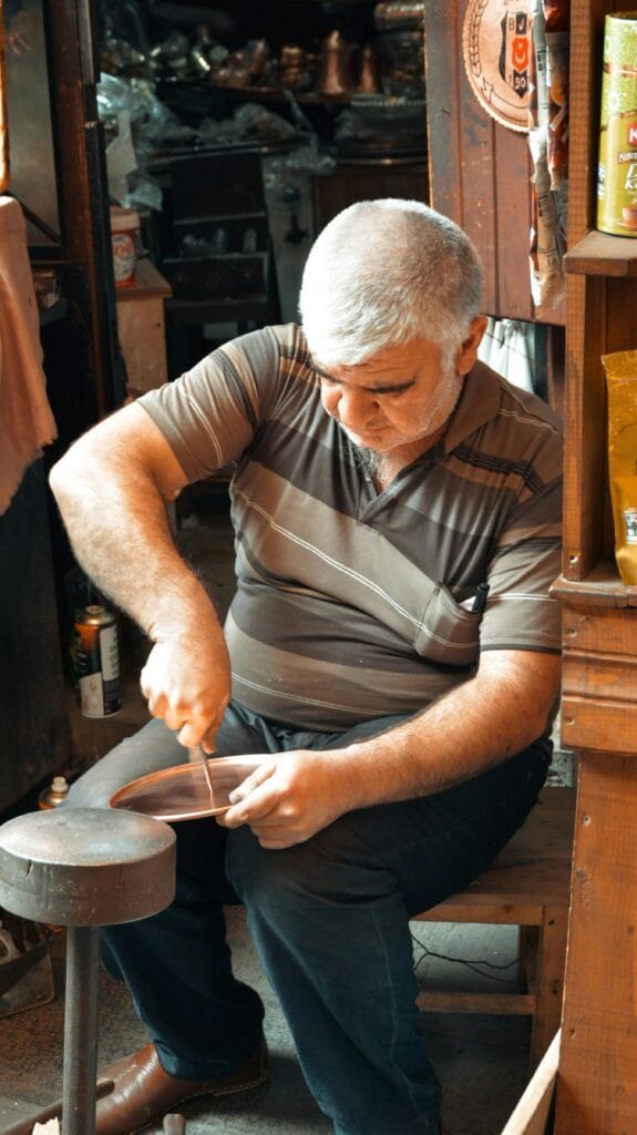 Top Things That Make Fez Special: History & Handicrafts 78 Brass and copper engraving is a traditional Moroccan craft that requires incredible skill and precision. In Fez, this ancient art is particularly prominent in the Njarine Square, where artisans meticulously work with brass, copper, and other metals to create stunning decorative items and functional pieces like trays, lamps, and bowls.The process of engraving involves hand-carving intricate patterns and arabesque designs into the metal surface, often inspired by Islamic art and geometric shapes. These designs are not only beautiful but carry deep cultural significance, representing the rich heritage of Morocco.🌟 Why This Craft Matters:
Artistic Expression: Brass and copper engraving reflects the Moroccan spirit and artistry, with each piece being a unique work of art.Timeless Craftsmanship: The intricate work done by the artisans ensures that each item is highly valued for its beauty and durability.Cultural Significance: These items are more than just decorations — they embody the history and traditions of Moroccan craftsmanship.
