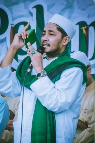 A serene interior courtyard of a traditional religious building in Fez (possibly the Zawiya of Sidi Ahmed Tijani), featuring a central fountain and arches. The image represents Fez's identity as Morocco's spiritual and intellectual capital and a center for Sufi learning and contemplation.