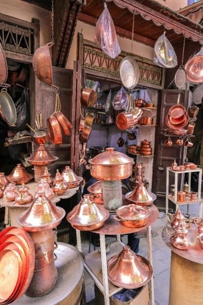 The peaceful central courtyard of the historic Seffarine Madrasa in Fez. The architecture features symmetrical pillars, and beautiful Moroccan zellige tilework, reflecting the institution's architectural excellence. This Marinid-era madrasa is a symbol of knowledge and cultural heritage near the famous Al-Qarawiyyin Library and the Copper Market.