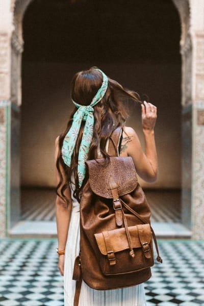 A historic, weathered brick archway, symbolizing one of Fez’s iconic gates, standing as a guardian to the city's ancient history. The view through the arch frames the sprawling rooftops of the Old Medina (Fes El Bali), welcoming visitors to a world of preserved tradition and heritage.
