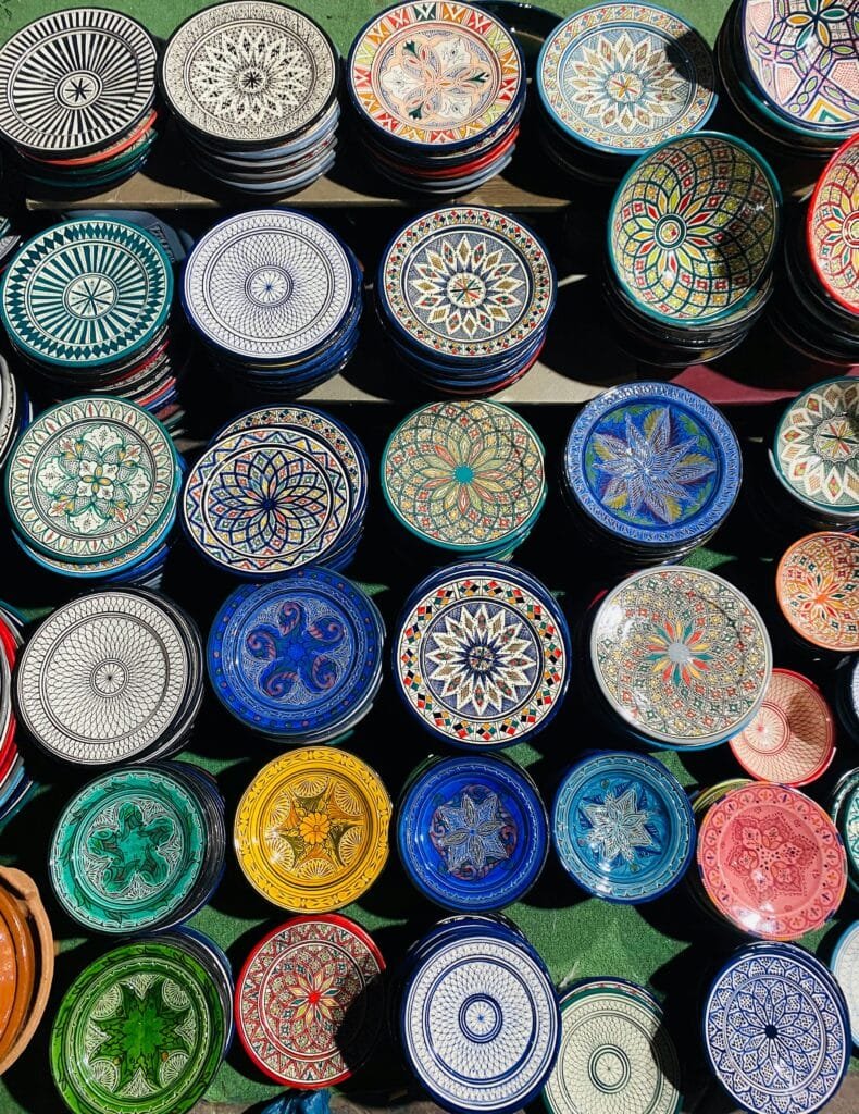Fez Shopping Guide: What to Buy in Morocco’s Craft Capital 14 The tagine is a stunning example of traditional pottery as well as a representation of Moroccan cuisine. Fez’s hand-painted tagine pots are a beautiful addition to any kitchen because of their vivid colors and patterns. They can also be used to cook Moroccan stews slowly.Both decorative and cooking-grade versions are available in many stores. A tagine is the ideal choice if you enjoy cooking or just want a distinctive memento that captures Moroccan culture.When choosing souvenirs in Fez, try to buy directly from artisans or cooperatives to support local craftsmanship. Look for items that are handmade, sustainable, and connected to Moroccan culture — they’ll have more meaning and make your travel memories last longer.