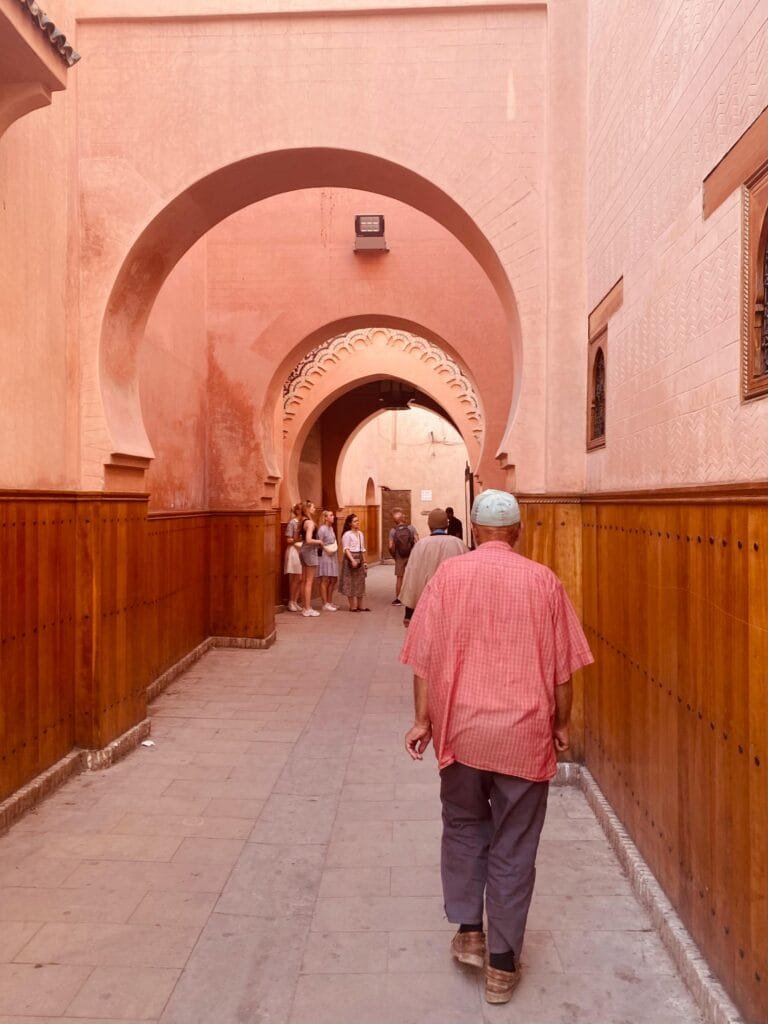 Why Is Fez, Morocco, Famous? 5 A panoramic view of the ancient medina of Fez at sunset, with its maze-like rooftops, towering minarets, and ochre-colored buildings glowing in warm light. The historic Al-Qarawiyyin Mosque rises at the center, surrounded by bustling alleyways that have remained unchanged for centuries. The image captures the essence of a city known for its deep spiritual heritage, intellectual legacy, and timeless craftsmanship—a living testament to Morocco's rich past and enduring soul.