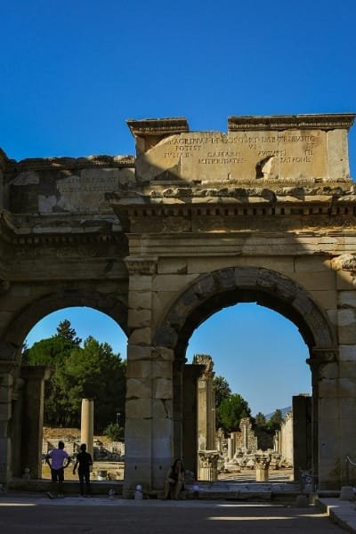 The monumental ruins of the Roman city of Volubilis (likely an archway with Latin inscription). Represents an archaeological tour showcasing the Roman presence and ancient history near Meknes and Fes.