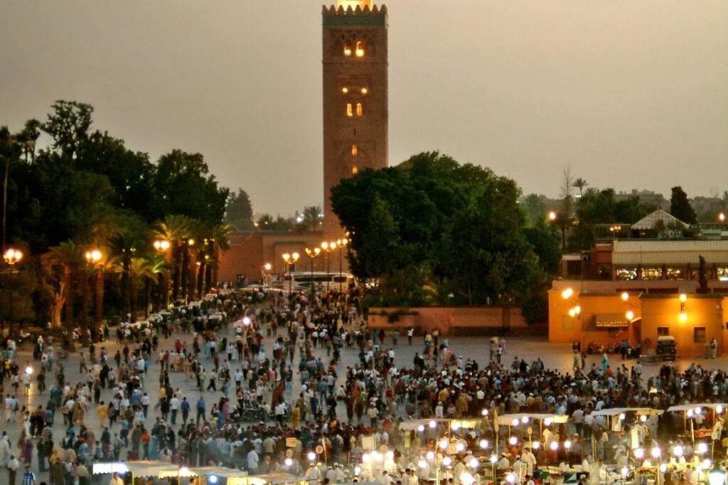 The vibrant night scene of Jemaa el-Fnaa square in Marrakech, showcasing the rich culture and history of Morocco. This image reflects the diverse experiences available, from imperial cities like Marrakech to the Atlas Mountains, Sahara Desert, and coasts.