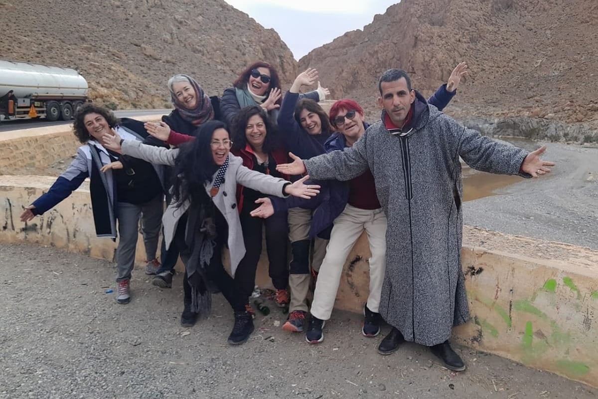 Professional driver assisting an elegant female client into a luxury vehicle, illustrating Casacado Voyageurs' commitment to comfortable, clean, and expert transfer services across Morocco.