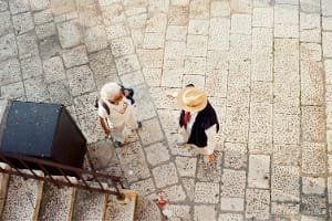 Tourist with guide in the stone alleys of Fes Old Medina, Morocco.
