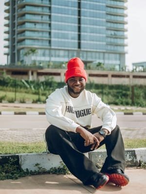 A professional driver smiling and greeting a client next to the baggage carousel at Fes Airport, illustrating a well-coordinated two-way transfer service with clean cars and professional drivers.