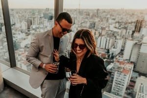 A smiling, satisfied customer in a professional setting with a laptop, reflecting the smooth planning and highly positive experience of the best flexible Fes tour.