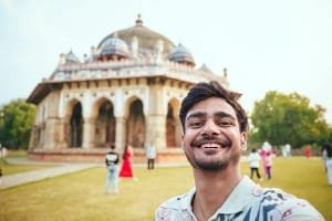 A satisfied female tourist smiling happily outdoors, representing the authentic and highly praised guided tour experience with Guide Abdul in Fes, Morocco.