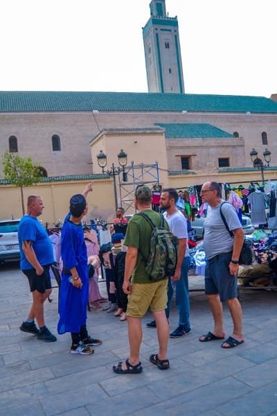 A collage of happy tourists and professional local guides taking selfies inside the Fes Medina, showcasing the social, fun, and hassle-free 5-6 hour group tour experience.