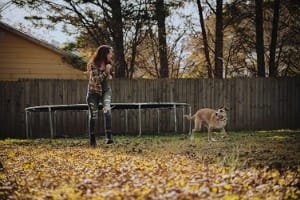 A professional Fes guide interacting closely with attentive tourists in a historical courtyard, reflecting the guide's friendly demeanor, language skills, and personalized, non-touristy cultural tour experience.