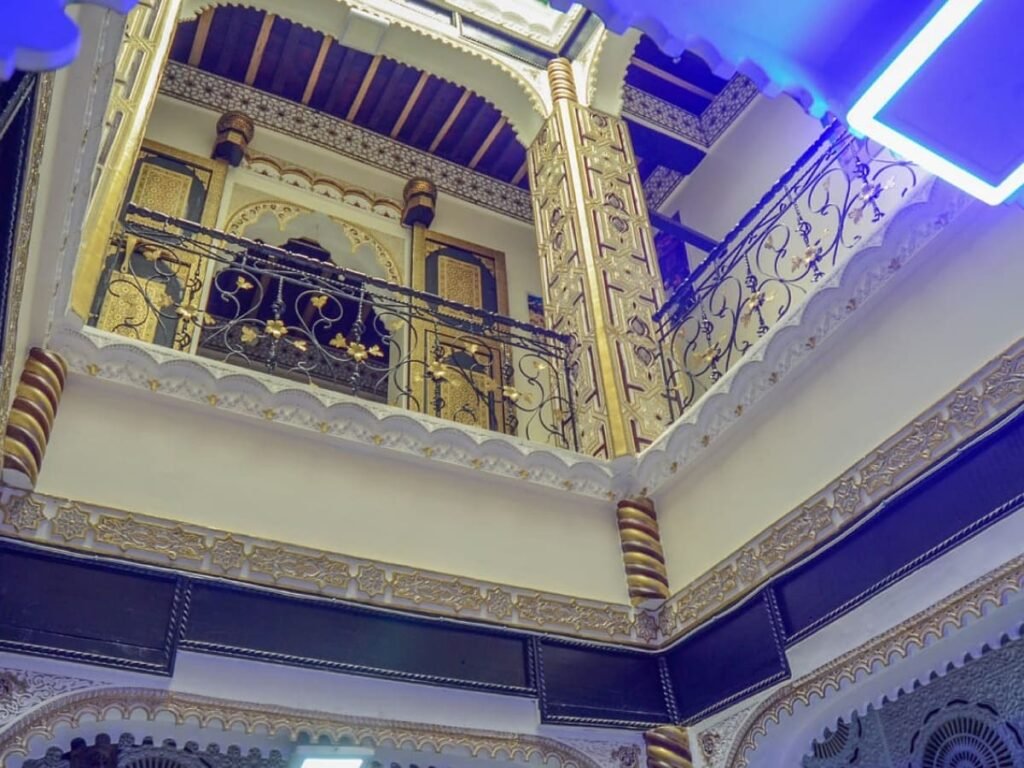 The grand interior of LA CASA DAR RAYAN guesthouse, showcasing the stunning gold and black Moroccan Zellige, ornate staircase, and access to all private facilities, including 3 guest rooms, rented as a whole house.